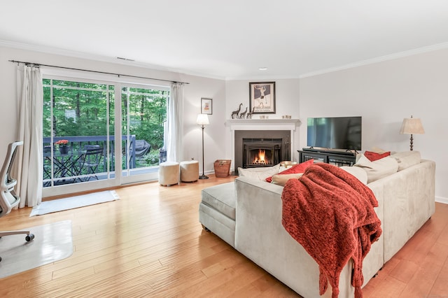 123 Old Belden Hill Rd Apt 41, Norwalk, CT 06850 - living room with crown molding, a warm lit fireplace, light wood-type flooring, and recessed lighting