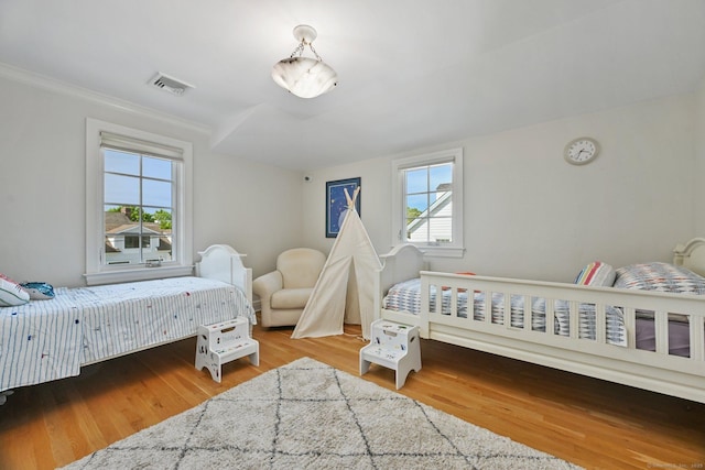 144 S Ave, New Canaan, CT 06840 - bedroom featuring multiple windows, wood finished floors, and crown molding