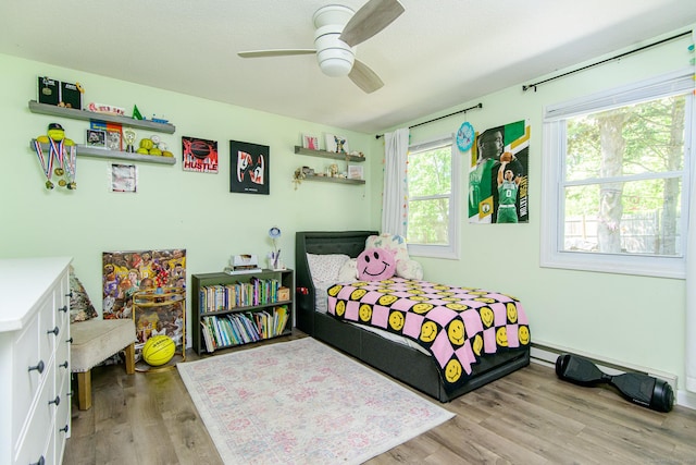 bedroom with wood finished floors and ceiling fan