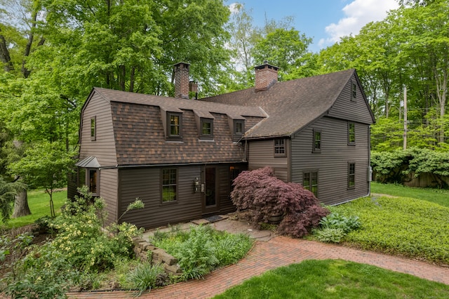 804 Forest Rd, North Branford, CT 06472 - view of front of house featuring roof with shingles, a front yard, and a chimney