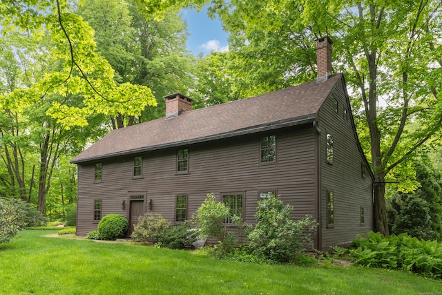 804 Forest Rd, North Branford, CT 06472 - view of side of property with a chimney, a lawn, and roof with shingles