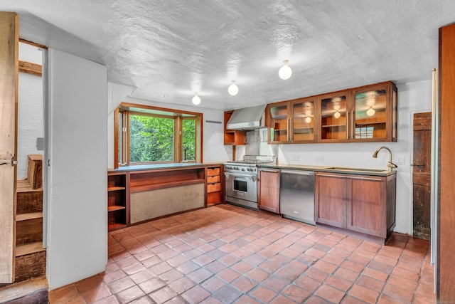 804 Forest Rd, North Branford, CT 06472 - kitchen featuring stainless steel appliances, wall chimney exhaust hood, brown cabinetry, glass insert cabinets, and a sink