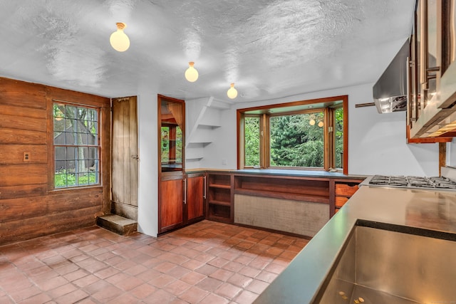804 Forest Rd, North Branford, CT 06472 - kitchen with a textured ceiling, brown cabinetry, and a sink
