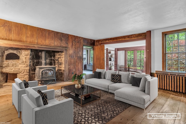 804 Forest Rd, North Branford, CT 06472 - living room featuring a wood stove, hardwood / wood-style floors, plenty of natural light, and wooden walls