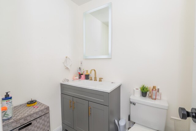 half bath with vanity and toilet