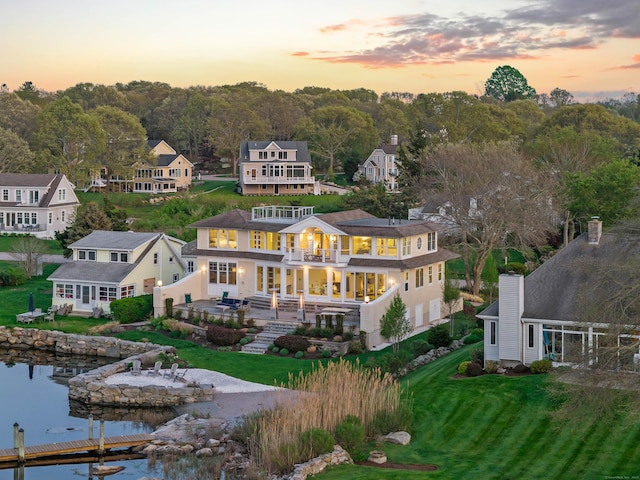 52 Old N Rd, Stonington, CT 06355 - back of property featuring a balcony, a water view, a lawn, and a patio area