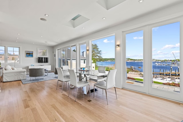 52 Old N Rd, Stonington, CT 06355 - dining room with a water view, light wood-style floors, a skylight, and recessed lighting