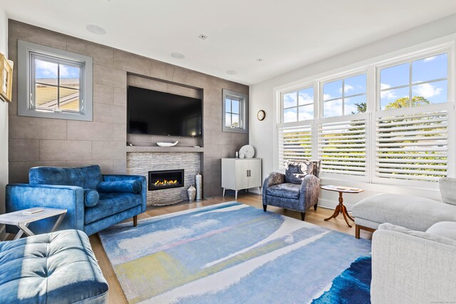 52 Old N Rd, Stonington, CT 06355 - living area featuring wood finished floors, a fireplace, and tile walls