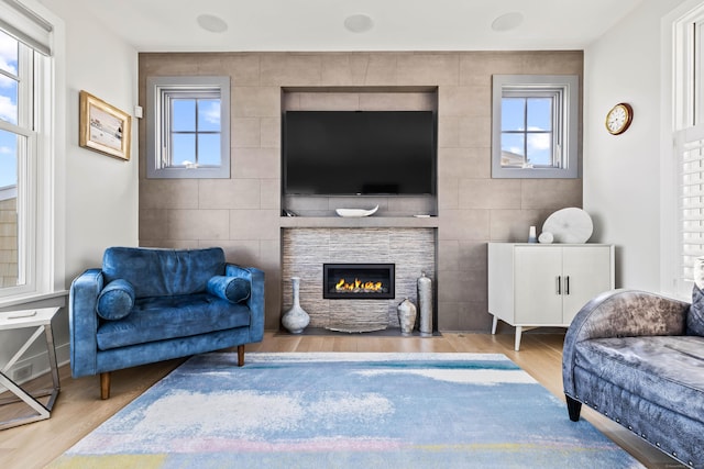 52 Old N Rd, Stonington, CT 06355 - living room with wood finished floors, healthy amount of natural light, a fireplace, and tile walls