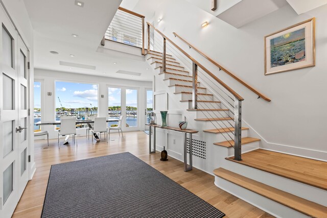 52 Old N Rd, Stonington, CT 06355 - stairway with wood finished floors and a water view