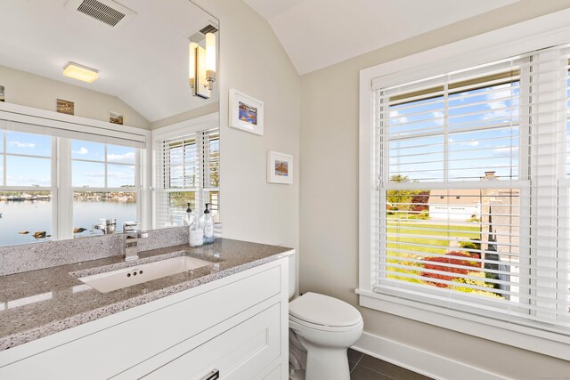 52 Old N Rd, Stonington, CT 06355 - half bathroom featuring lofted ceiling, plenty of natural light, toilet, tile patterned floors, and a water view