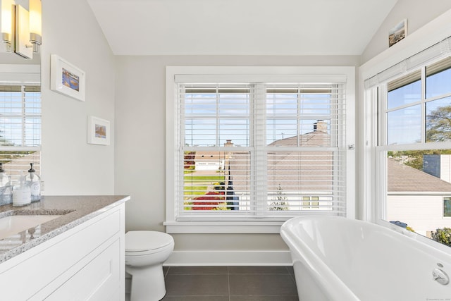 52 Old N Rd, Stonington, CT 06355 - bathroom featuring lofted ceiling, tile patterned flooring, a freestanding bath, vanity, and toilet