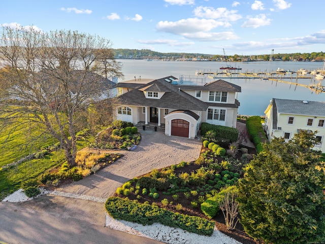 52 Old N Rd, Stonington, CT 06355 - view of front of house featuring driveway, a water view, a garage, and roof with shingles