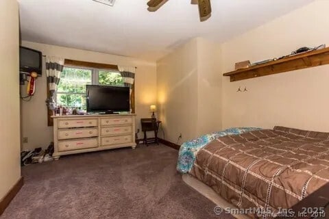 31 Bayberry Ln, Lisbon, CT 06351 - bedroom with dark carpet, baseboards, and ceiling fan