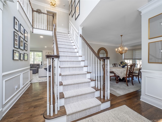 30 Wilton Hunt Rd Unit 30, Wilton, CT 06897 - stairway with crown molding, wood finished floors, a decorative wall, a chandelier, and wainscoting