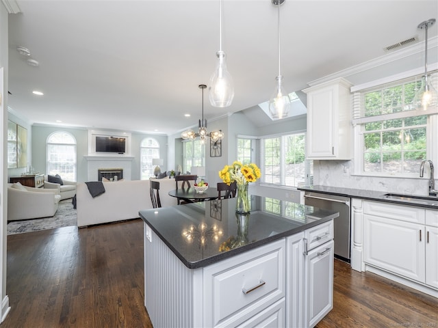 30 Wilton Hunt Rd Unit 30, Wilton, CT 06897 - kitchen featuring a sink, stainless steel dishwasher, crown molding, a center island, and plenty of natural light