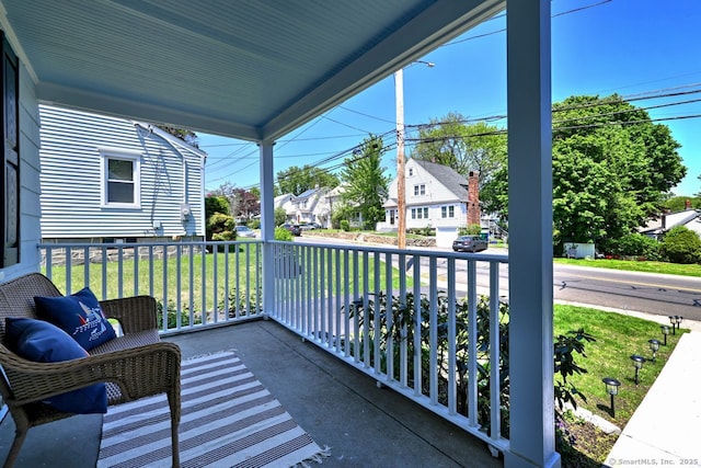 balcony featuring covered porch and a residential view