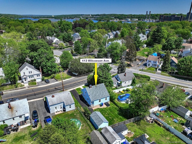 aerial view of property and surrounding area featuring nearby suburban area