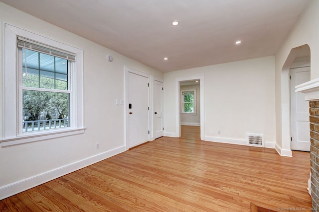 unfurnished living room featuring healthy amount of natural light, baseboards, light wood-style flooring, and recessed lighting