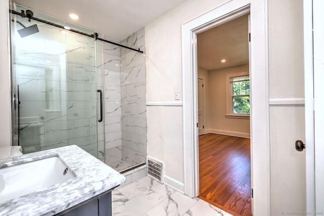 full bathroom featuring a marble finish shower, baseboards, recessed lighting, vanity, and marble finish flooring