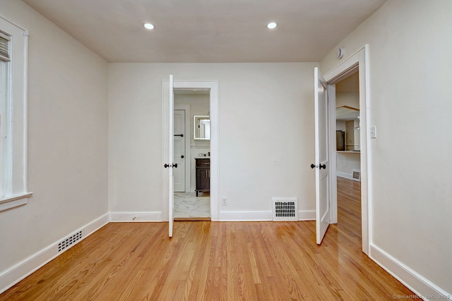 unfurnished bedroom with light wood finished floors, recessed lighting, and baseboards