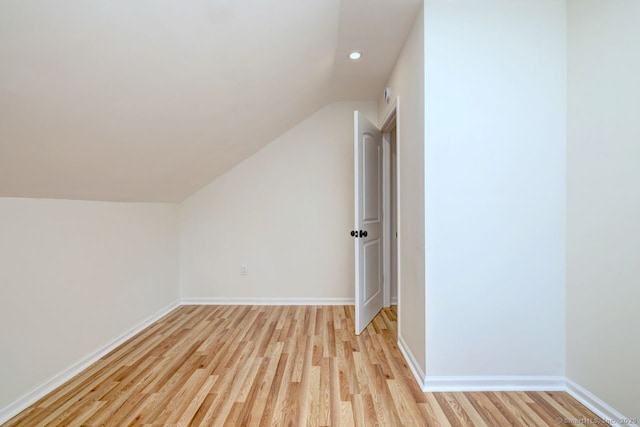 additional living space with light wood-style floors, lofted ceiling, recessed lighting, and baseboards
