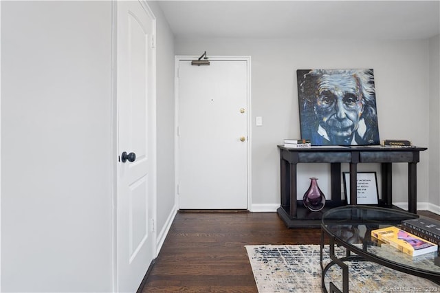 foyer entrance with wood finished floors and baseboards