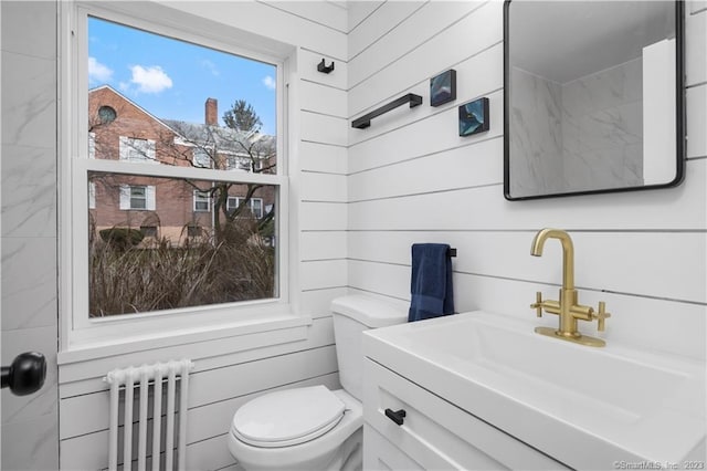 bathroom featuring radiator, toilet, and vanity