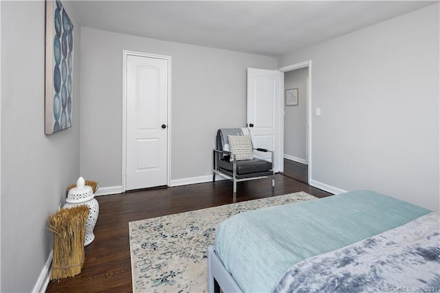 bedroom featuring wood finished floors and baseboards