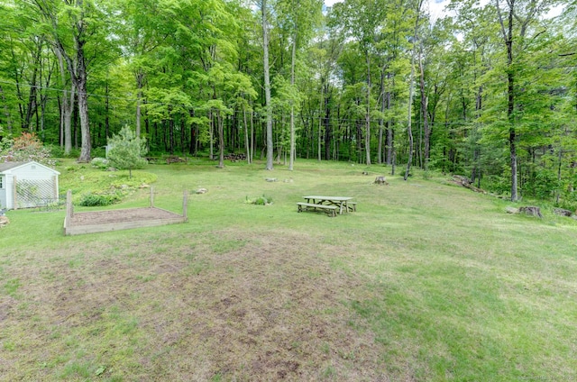 7 Parker Rd, Willington, CT 06279 - view of grassy yard with an outdoor structure, a vegetable garden, and a view of trees