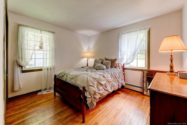 7 Parker Rd, Willington, CT 06279 - bedroom with a baseboard heating unit and light wood-style floors