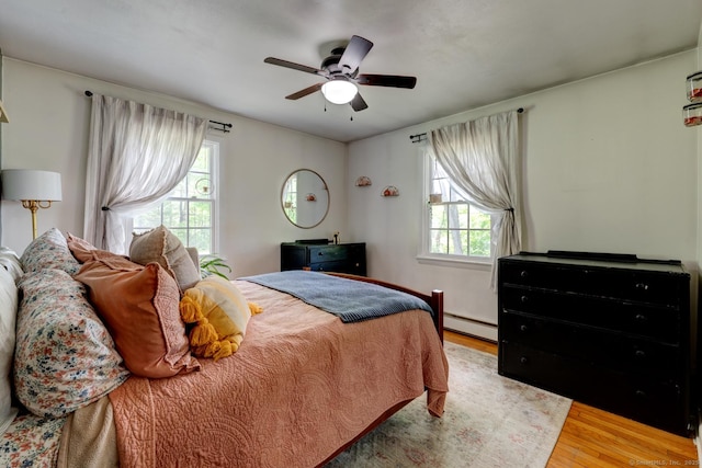 7 Parker Rd, Willington, CT 06279 - bedroom with baseboard heating, wood finished floors, multiple windows, and a ceiling fan