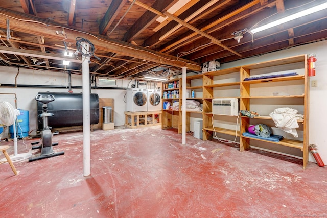 7 Parker Rd, Willington, CT 06279 - unfinished basement with heating fuel, washer and dryer, a water pressure tank, and a wall mounted air conditioner