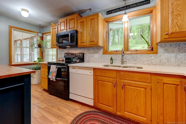 7 Parker Rd, Willington, CT 06279 - kitchen with double oven range, dishwasher, a sink, light wood-type flooring, and pendant lighting