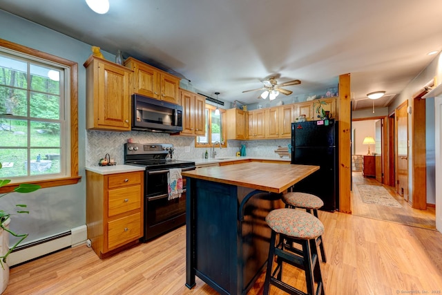 7 Parker Rd, Willington, CT 06279 - kitchen with black appliances, butcher block counters, light wood finished floors, and healthy amount of natural light