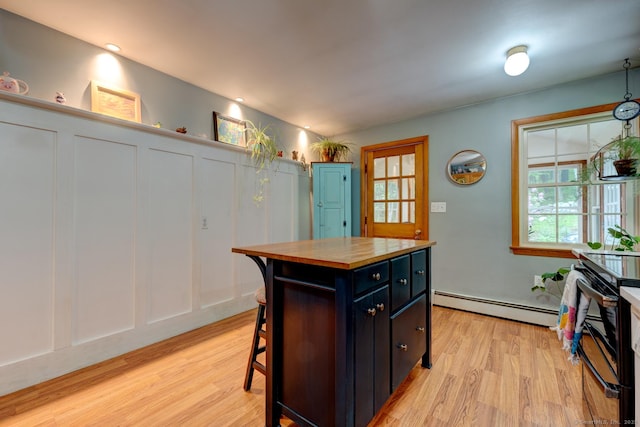 7 Parker Rd, Willington, CT 06279 - kitchen featuring a baseboard radiator, butcher block counters, light wood finished floors, black electric range, and a decorative wall