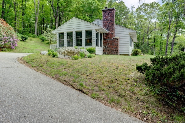 7 Parker Rd, Willington, CT 06279 - view of front of home featuring a chimney, a sunroom, and a front yard