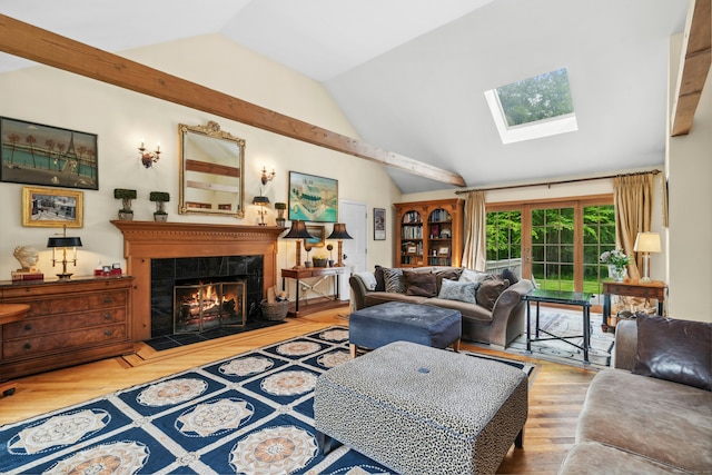 6 Galilee Way, Newtown, CT 06470 - living area featuring vaulted ceiling, a skylight, a tiled fireplace, and wood finished floors