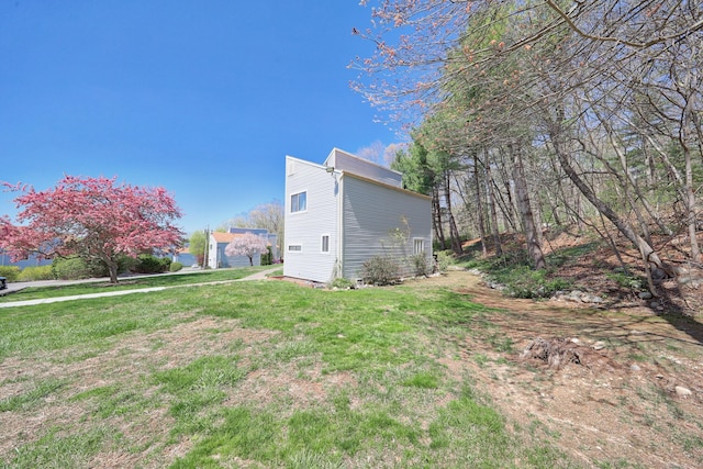 view of property exterior featuring a lawn