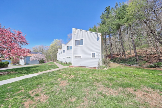 view of side of home featuring a yard