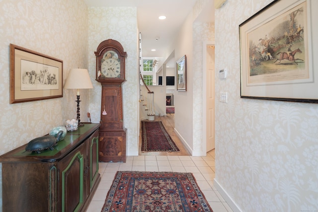 44 Hale Ln, Darien, CT 06820 - corridor with wallpapered walls, stairs, light tile patterned floors, and baseboards