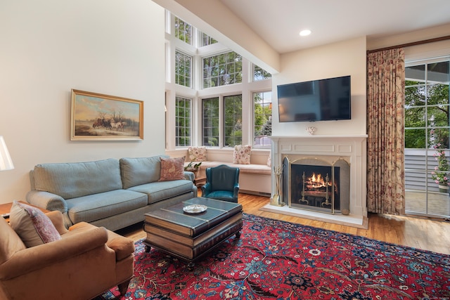44 Hale Ln, Darien, CT 06820 - living area with healthy amount of natural light, wood finished floors, a lit fireplace, and recessed lighting