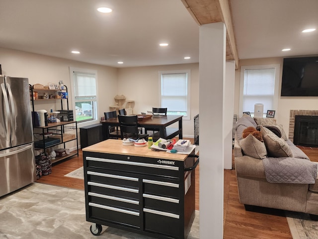 12 Flyers Dr, Norwich, CT 06360 - kitchen featuring freestanding refrigerator, recessed lighting, wood finished floors, and a brick fireplace