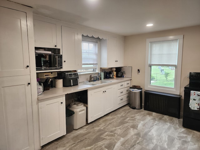 12 Flyers Dr, Norwich, CT 06360 - kitchen featuring black appliances, white cabinets, light countertops, a sink, and recessed lighting