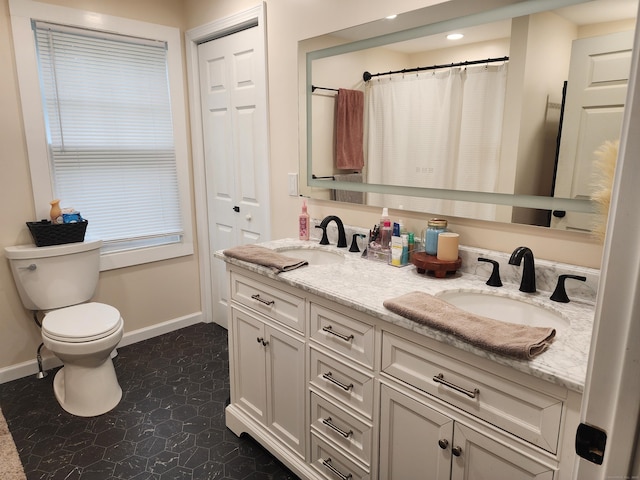 12 Flyers Dr, Norwich, CT 06360 - bathroom featuring baseboards, toilet, double vanity, recessed lighting, and tile patterned floors