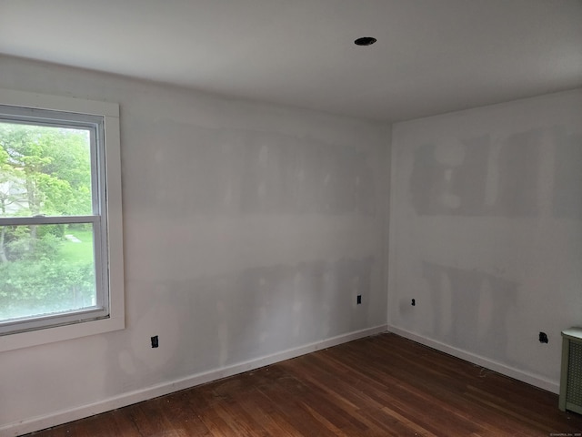 12 Flyers Dr, Norwich, CT 06360 - spare room with wood finished floors, plenty of natural light, and baseboards