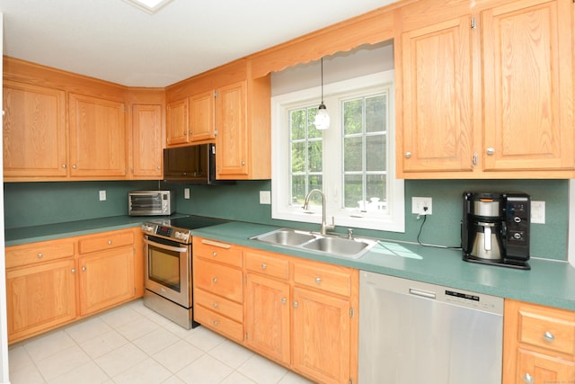 kitchen with stainless steel appliances, a sink, hanging light fixtures, and light tile patterned floors