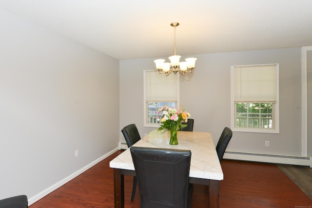 dining room featuring baseboard heating, a chandelier, dark wood finished floors, and baseboards