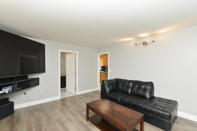 living room featuring light wood-style floors and baseboards