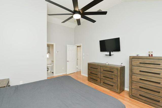 bedroom featuring light wood-type flooring, high vaulted ceiling, baseboards, ensuite bath, and ceiling fan